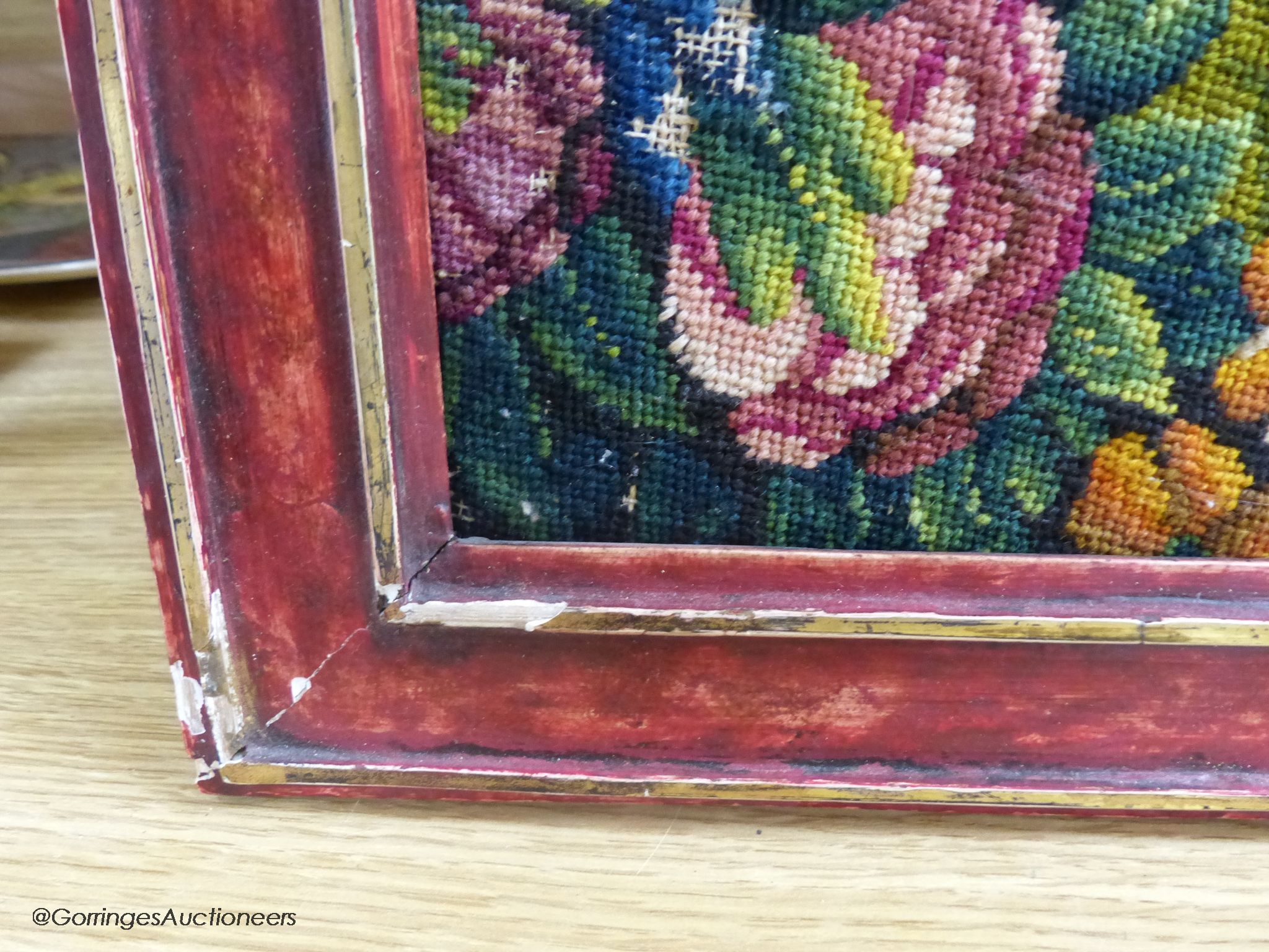 A framed 19th century woolwork panel depicting pomegranates, other fruit and flowers, 71 x 38cm